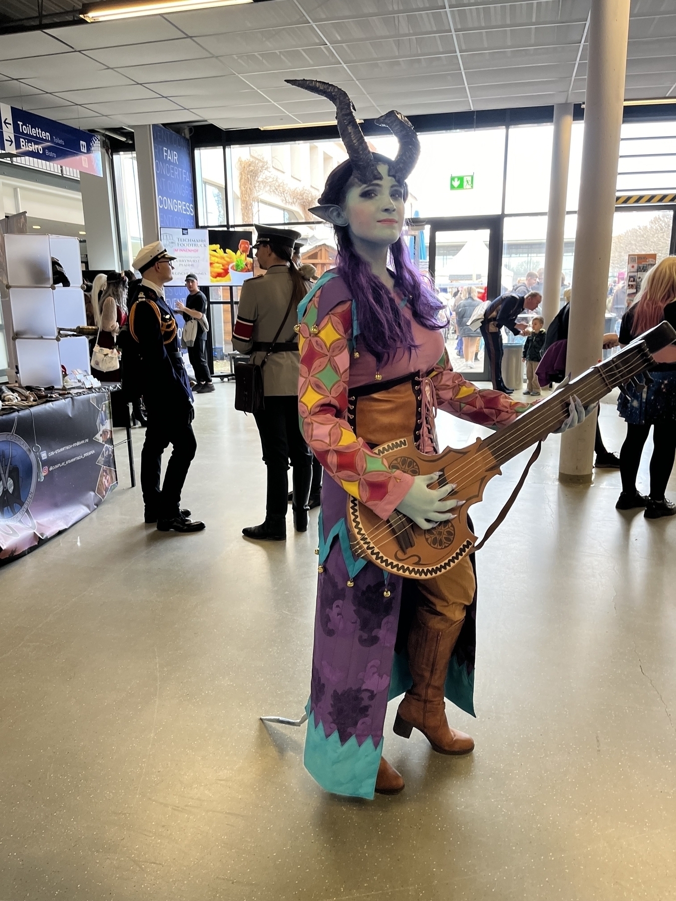 A cosplayer playing a female tiefling-bard