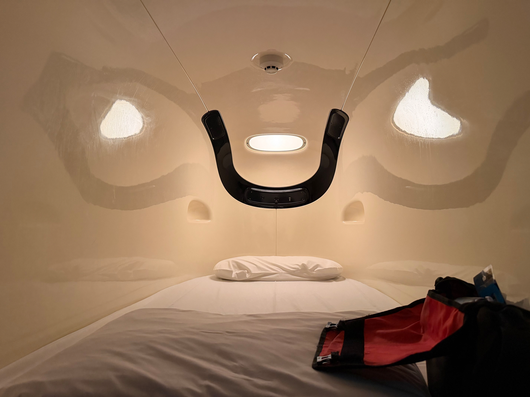 A small sleeping pod featuring a single bed.